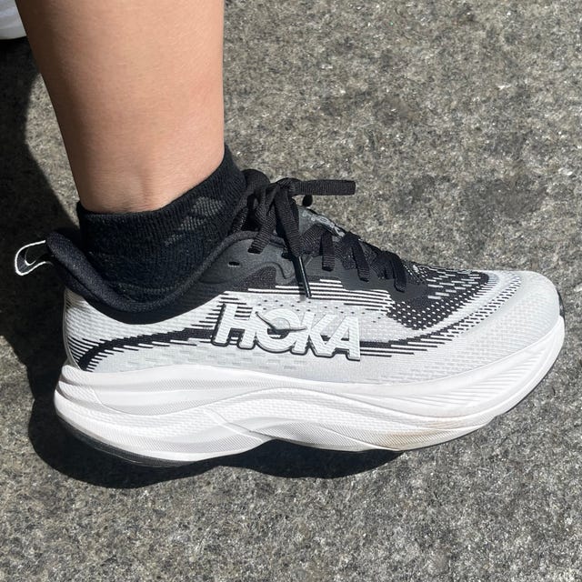 Sporty running shoe worn with a black sock.