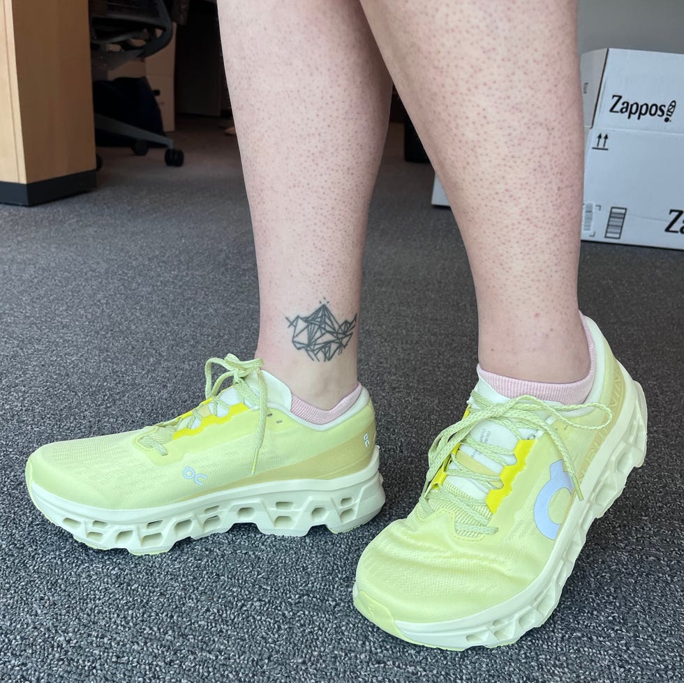 Footwear display featuring bright yellow athletic shoes and a tattoo. Footwear display featuring bright yellow athletic shoes and a tattoo.