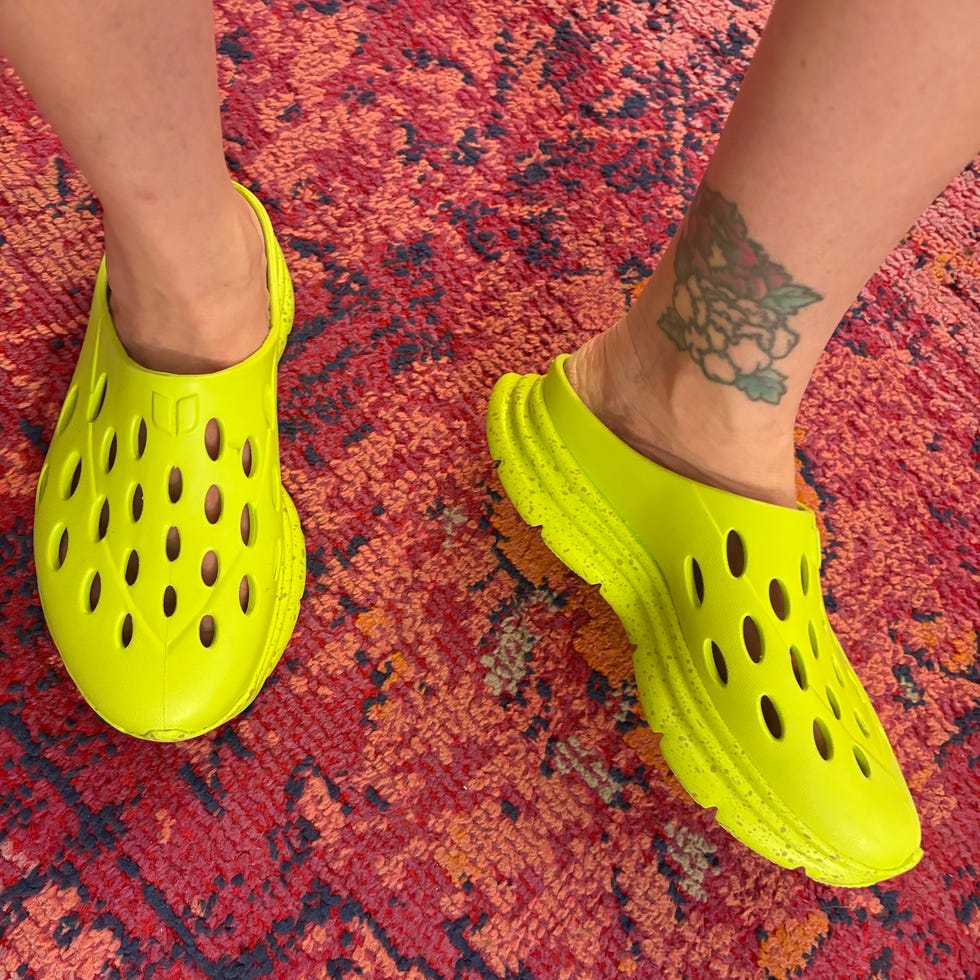 Yellow footwear worn on a patterned surface