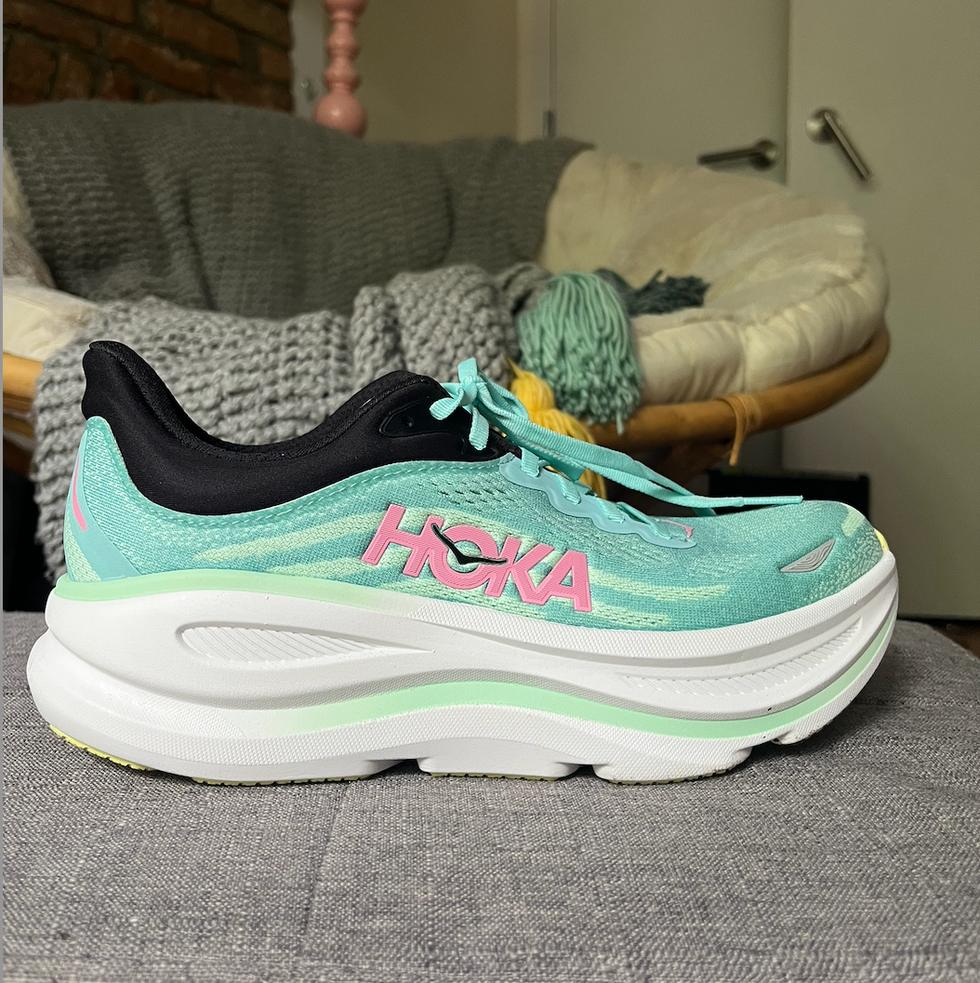 athletic shoe designed for running featuring a vibrant color scheme and brand logo athletic shoe designed for running featuring a vibrant color scheme and brand logo
